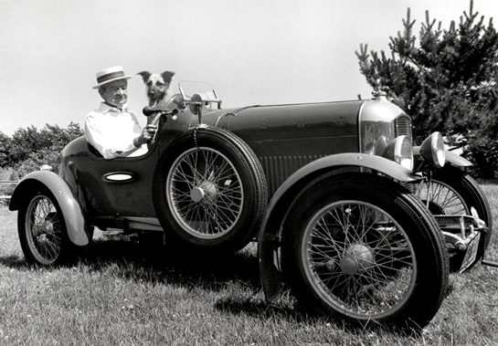 Posing with Shirley Batty's dog Nathan in the Amilcar sometime in the